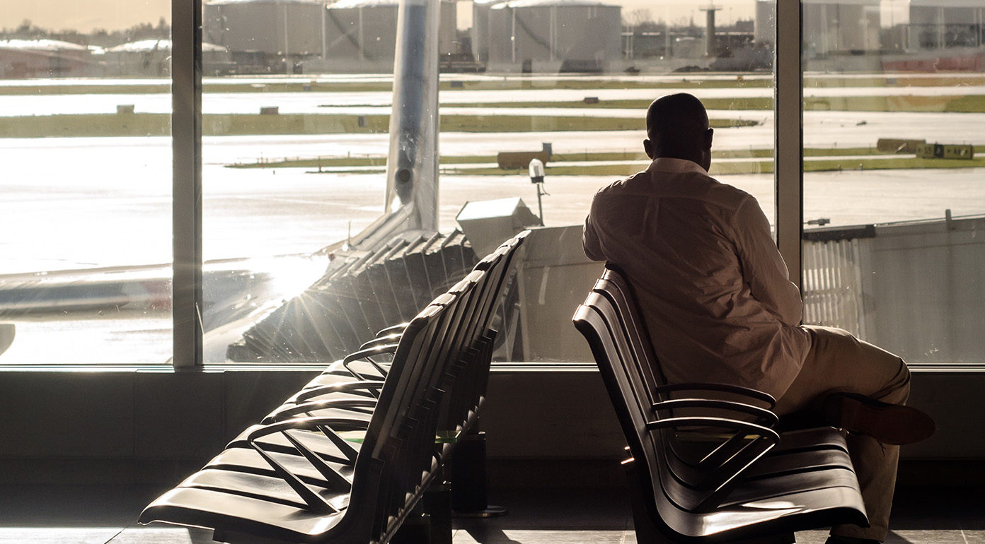 Man waiting at boarding gate.